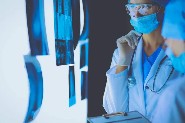 Two female women medical doctors looking at x-rays in a hospital. — Stock Photo, Image