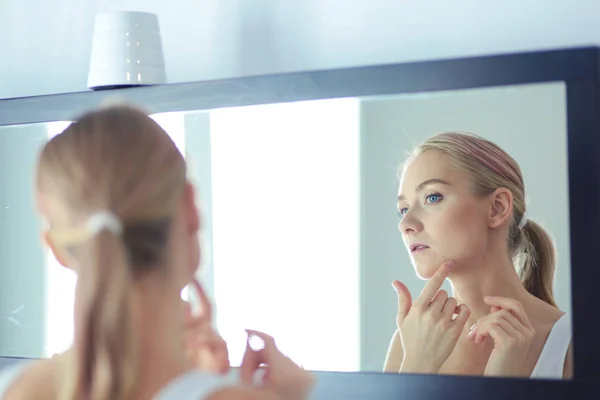 The beautiful young girl with a clean fresh skin touches with a hand a cheek — Stock Photo, Image