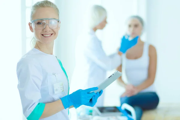 Beautiful woman face near doctor with syringe. — Stock Photo, Image