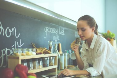 mutfak arka planı duran genç bir kadın portresi.