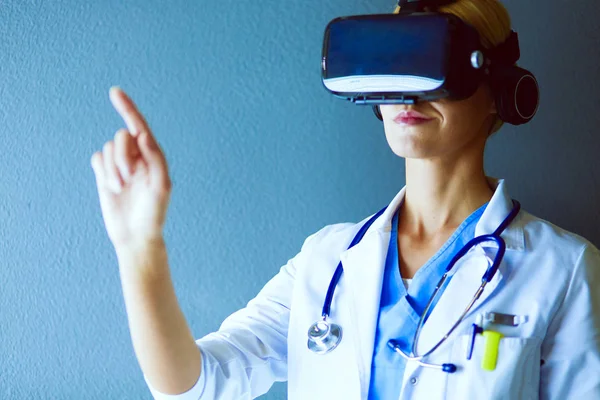 Female doctor wearing virtual reality glasses isolated on white background.