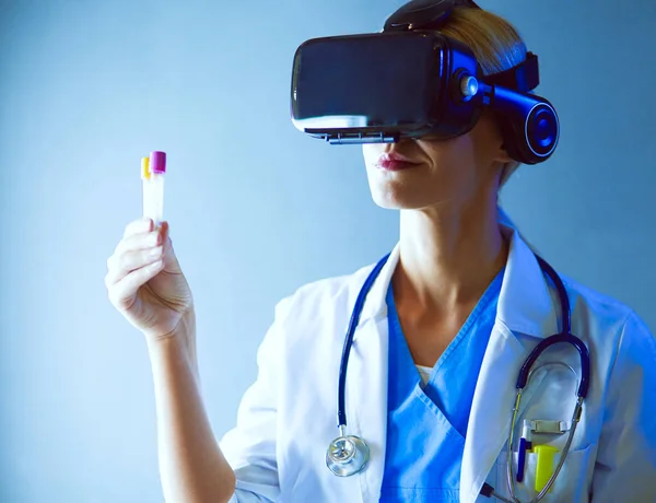 Female doctor wearing virtual reality glasses isolated on white background.