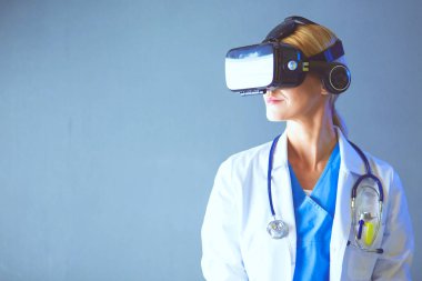 Sanal gerçeklik gözlüğü takan kadın doktor beyaz arka planda izole edilmiş..