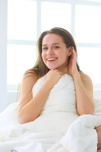 Молода біла жінка прикриває голову і вуха подушками — стокове фото