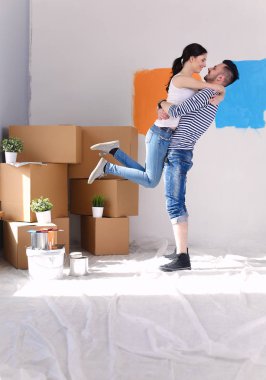 Mutlu genç çift yeni evin içinde hareket. Genç Çift