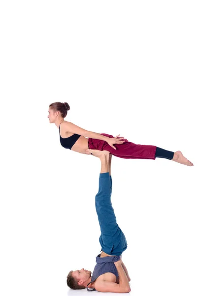 Young athletic couple practicing acroyoga. Balancing in pair. — Stock Photo, Image