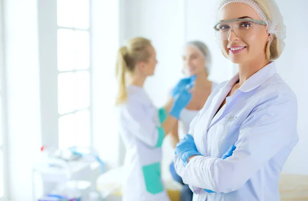 Beautiful woman face near doctor with syringe. — Stock Photo, Image