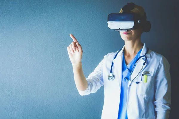 Female doctor wearing virtual reality glasses isolated on white background.