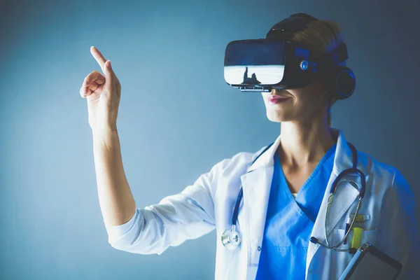 Female doctor wearing virtual reality glasses isolated on white background.