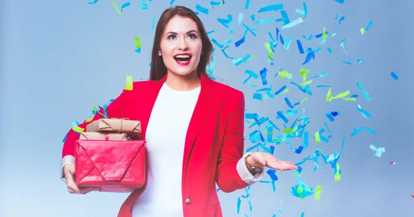 Beautiful happy woman with gift box at celebration party with confetti . Birthday or New Year eve celebrating concept — Stock Photo, Image
