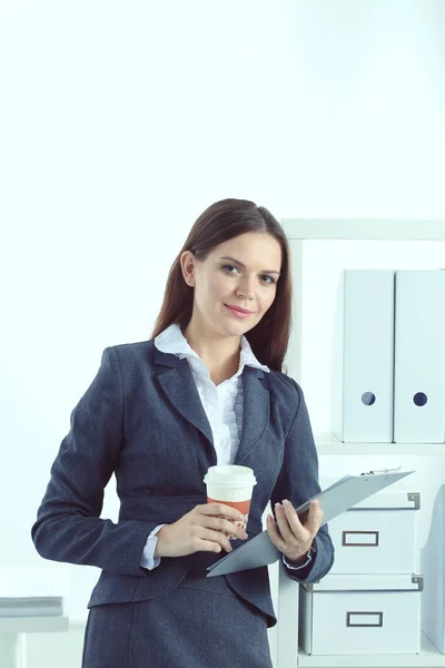Mulher de negócios em pé contra a janela do escritório segurando laptop. Empresária — Fotografia de Stock
