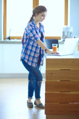 Güzel, genç, gülümseyen bayan doktor masada oturuyor ve yazıyor..