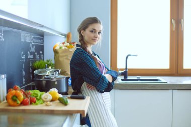 Mutfakta masada oturan genç kadın.