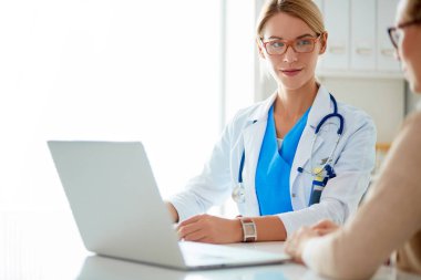 Doktor ve hasta çift masada oturmuş bir şey tartışıyorlar..