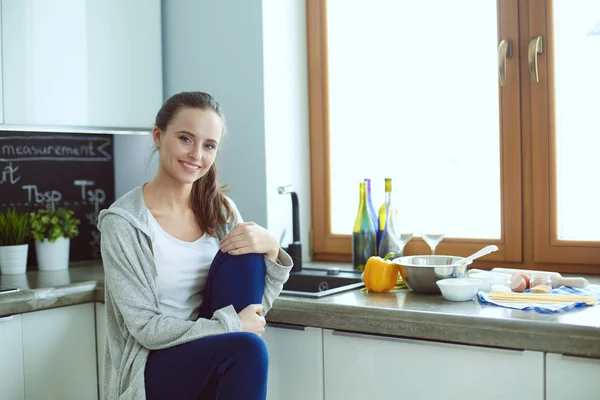 Woman in the kitchen. Cooking at kitchen.