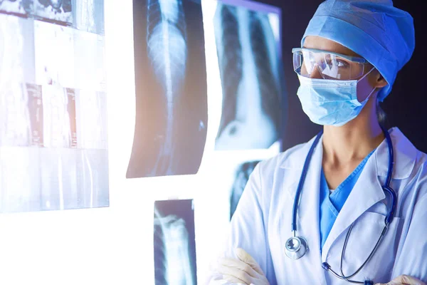 Image of attractive woman doctor looking at x-ray results. — Stock Photo, Image