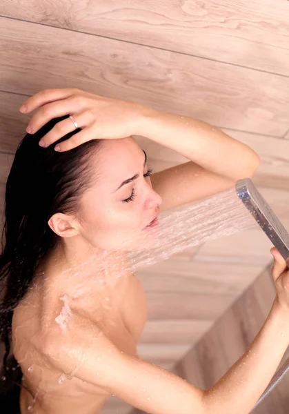 Young beautyful woman under shower in bathroom. — Stock Photo, Image