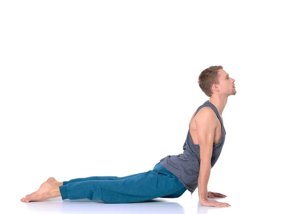 Hombre adulto haciendo ejercicio de yoga sobre fondo blanco —  Fotos de Stock