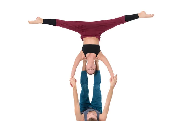 Young athletic couple practicing acroyoga. Balancing in pair — Stock Photo, Image