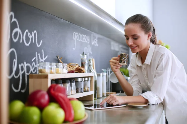 Porträt einer jungen Frau vor Küchenhintergrund. — Stockfoto