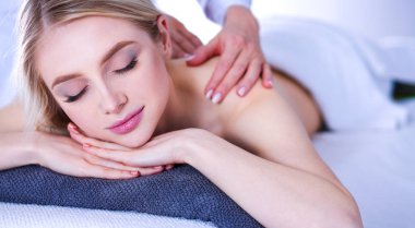Masaj masasında uzanmış gözleri kapalı rahatlayan genç bir kadın. - Kadın. Spa salonu