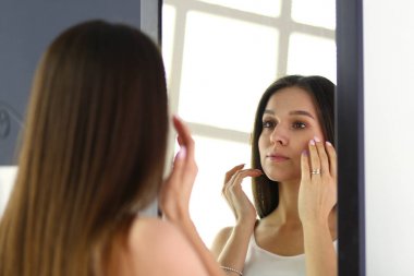 Genç kadın kendini evde aynada yansıma arıyor