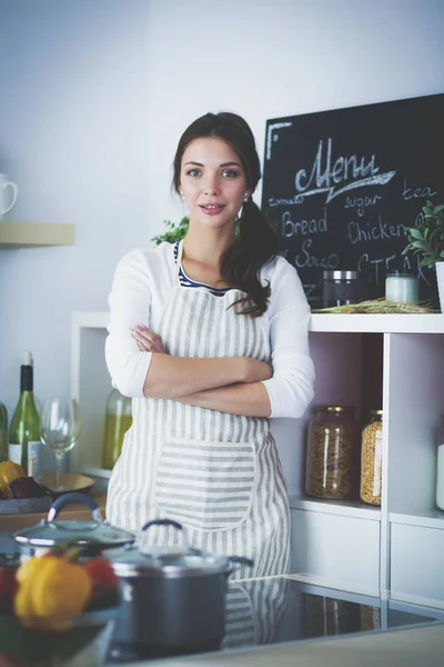Young woman standing near desk in the kitchen. Young woman . — Stock Photo, Image