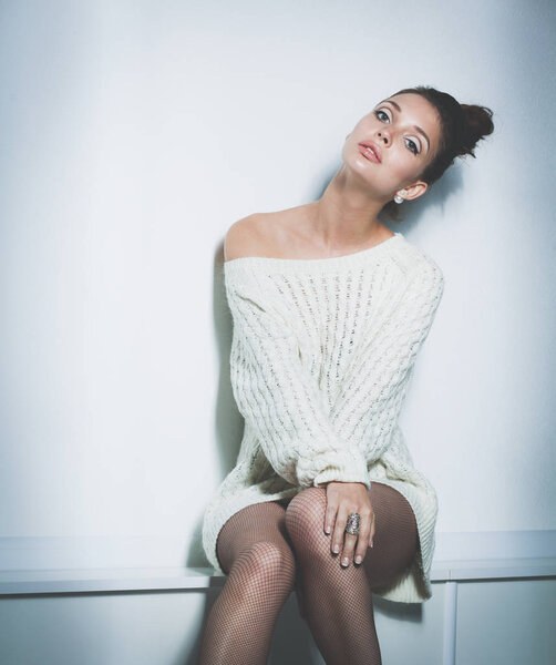 Portrait of a cute woman in sweater at home. Portrait of a cute woman