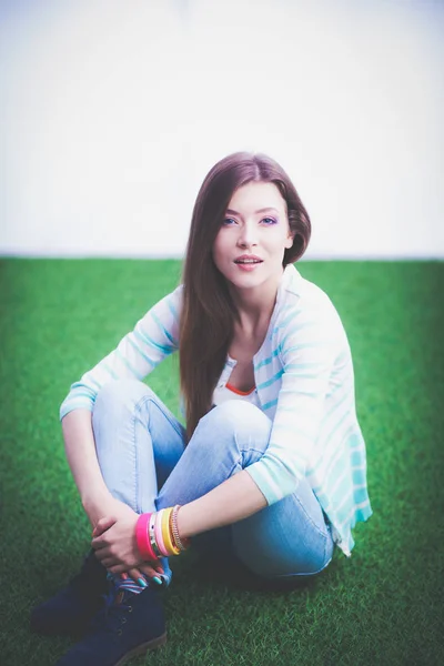 Una joven sentada sobre hierba verde. Portreit mujer joven — Foto de Stock