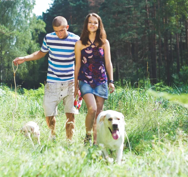 Young couple walking dog on the nature — Stock Photo, Image