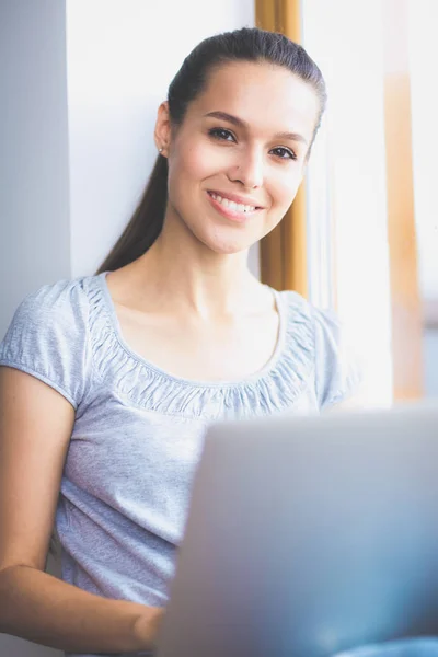 Joven hermosa mujer usando una computadora portátil en casa. Joven hermosa mujer . — Foto de Stock