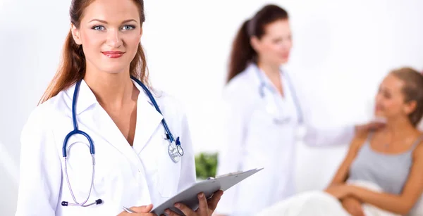 Two woman doctors standing near patient at hospital — Stock Photo, Image