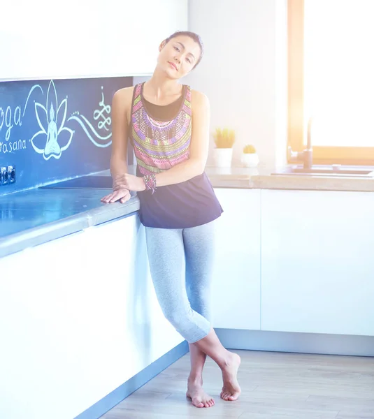 Portrait of smiling woman holding in her hand a yoga mat while standing at studio. Yoga. Woman. Wellness — Stock Photo, Image