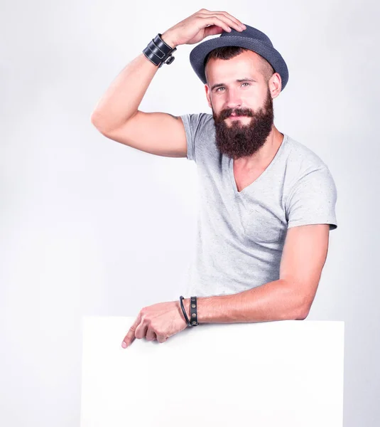 Portré fiatal férfi kalapban áll közel üres, elszigetelt fehér háttér — Stock Fotó