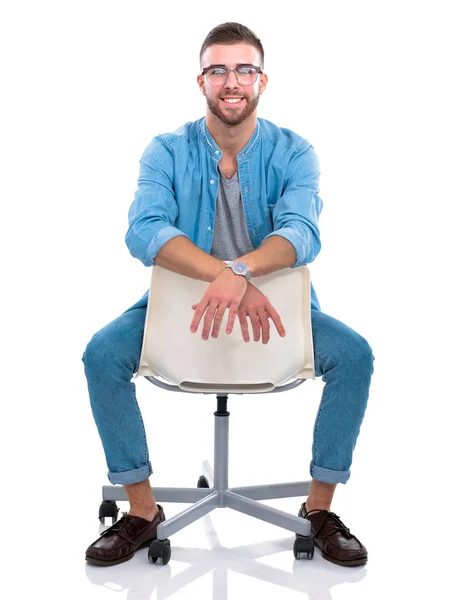 Young man sitting on the chair isolated over white background. Startupper. Young entrepreneur. — Stock Photo, Image