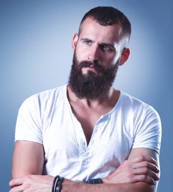 Ayakta, gri arka plan üzerinde izole yakışıklı adam portresi