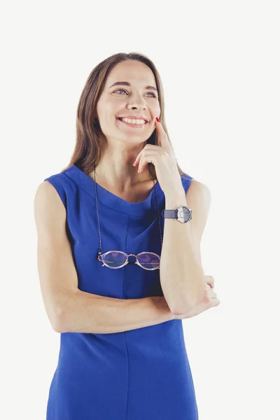 Smiling woman in dress with her arms folded against white background — Stock Photo, Image