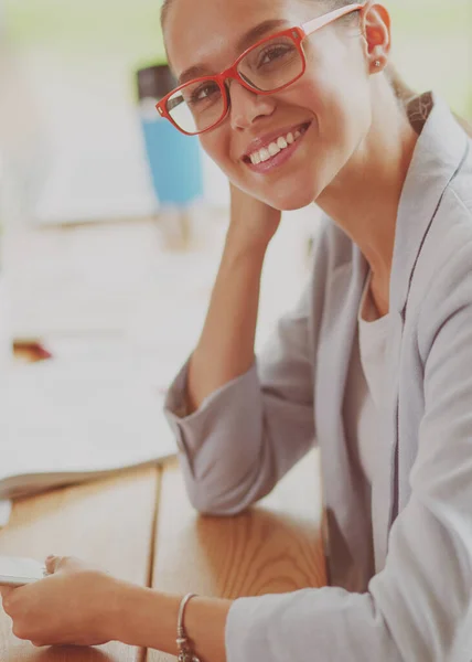 Business woman sitting in her office using a tablet computer. — Stock Photo, Image