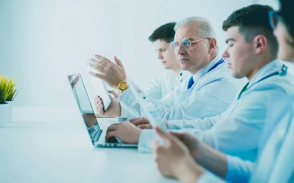 Medical team sitting and discussing at table — Stock Photo, Image