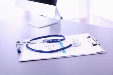 Tıbbi ekipman: Beyaz arka planda mavi steteskop ve tablet. Tıbbi ekipman