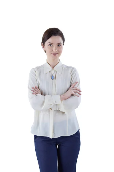 Portrait of cheerful young woman standing arms crossed over white background — Stock Photo, Image