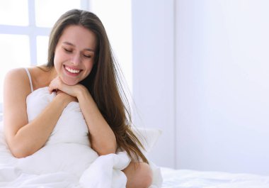 Güzel bir kadın yatağında uzanıyor..