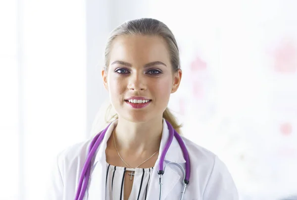 Médecin souriante avec stéthoscope médical en uniforme debout — Photo