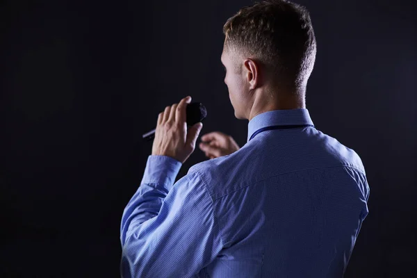 Businessman speech concept, talking with microphone in conference hall — Stock Photo, Image