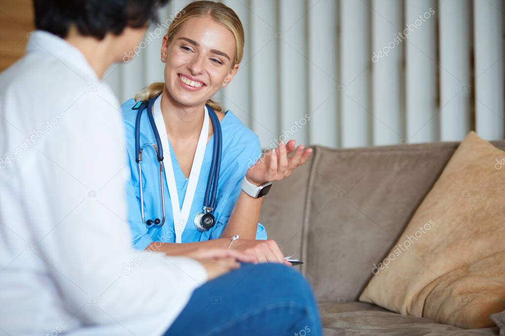 Woman doctor explaining diagnosis to her female patient