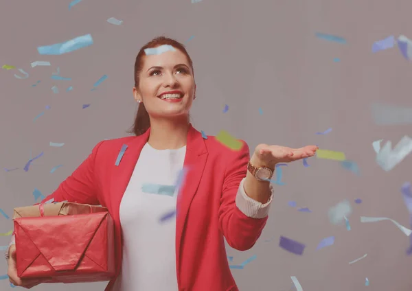 Hermosa mujer feliz con caja de regalo en la fiesta de celebración con confeti. Cumpleaños o Nochevieja celebrando el concepto — Foto de Stock