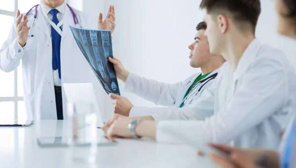 Medical team sitting and discussing at table — Stock Photo, Image