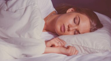 yatakta uyuyan güzel genç sarışın kadın