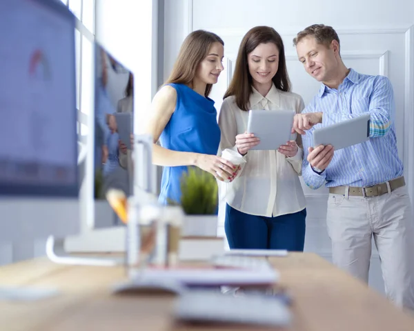 Group of young colleagues using laptop at office — Stock Photo, Image