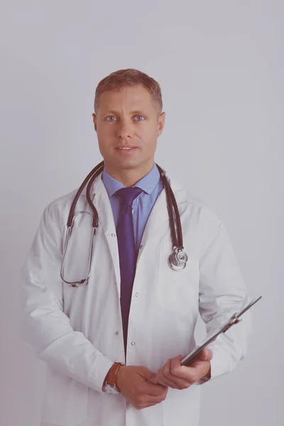 Male doctor standing with folder, isolated on white background — Stock Photo, Image